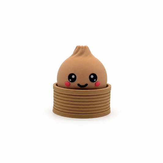 Dumplin clicker, a 3D printed dumpling fidget clicker sitting in a steam basket