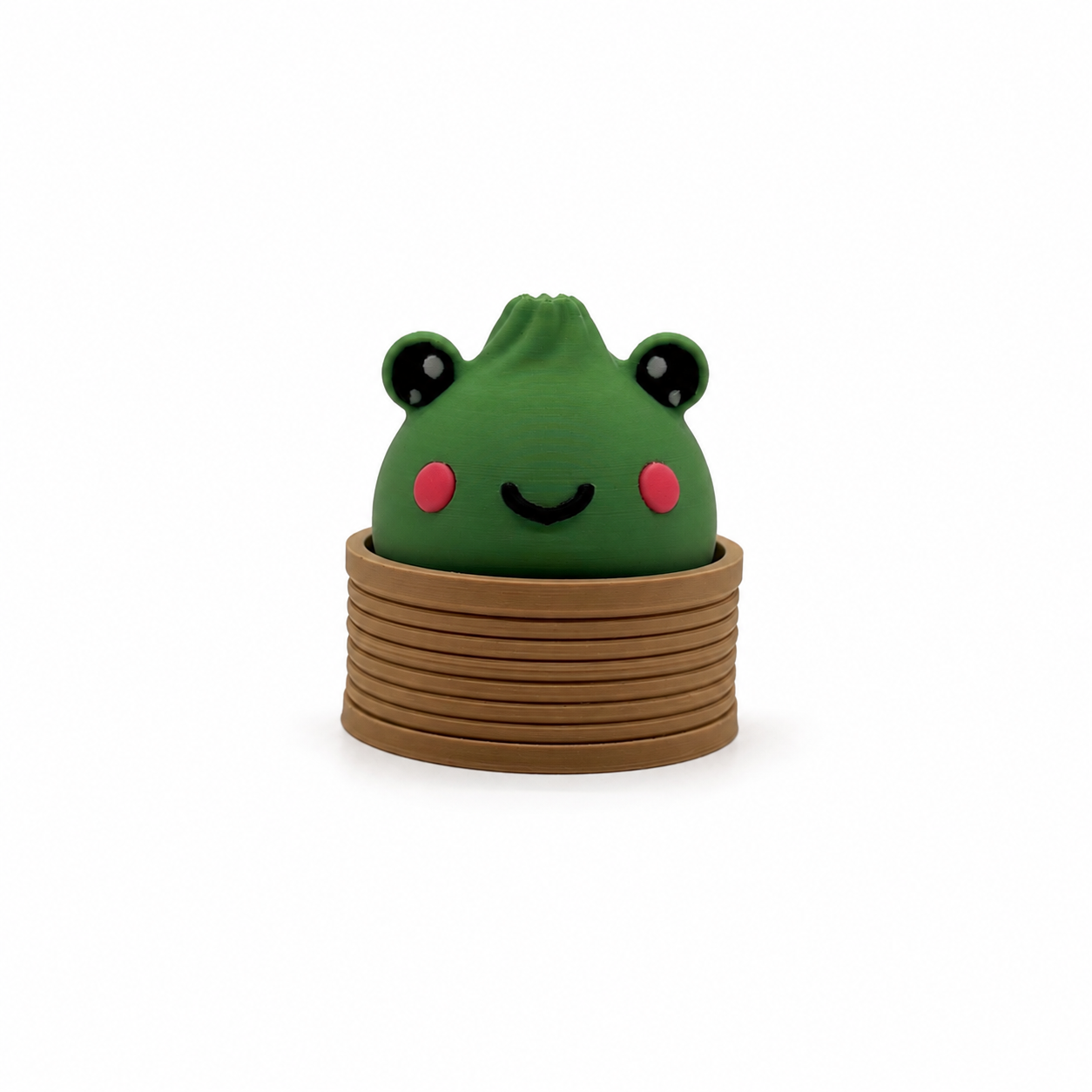 Wasabi the Frog clicker, a 3D printed frog dumpling fidget clicker sitting in a steam basket